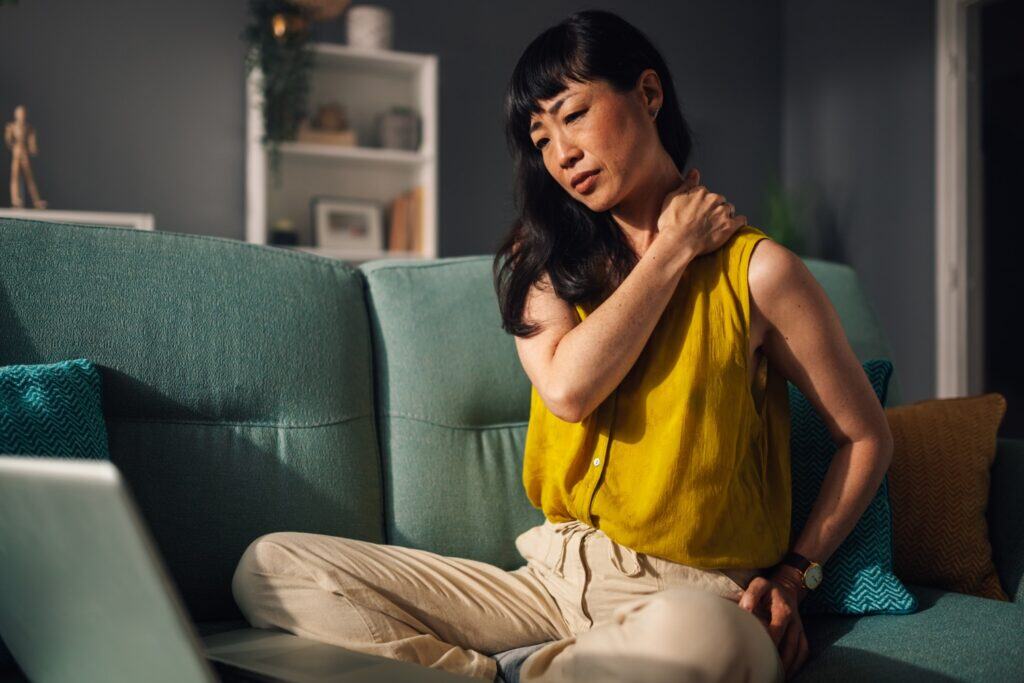 woman holding her neck dues to her nerve pain bothering her