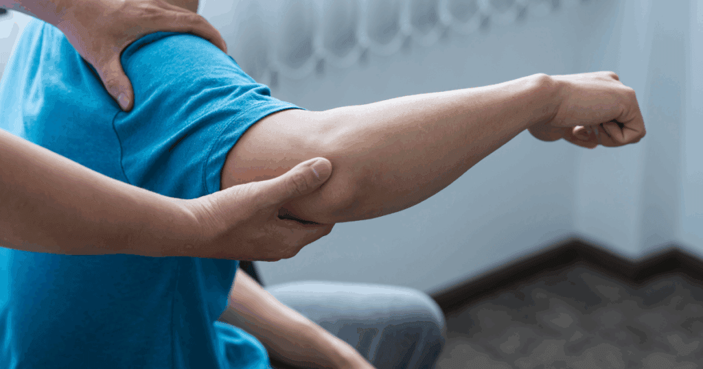 THERAPIST CHECKING A MAN'S ARM FOR MUSCLE WEAKNESS