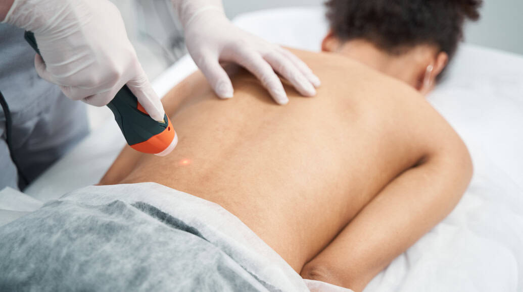 Doctor Reviewing Spine Xray With Patient Booth, TX